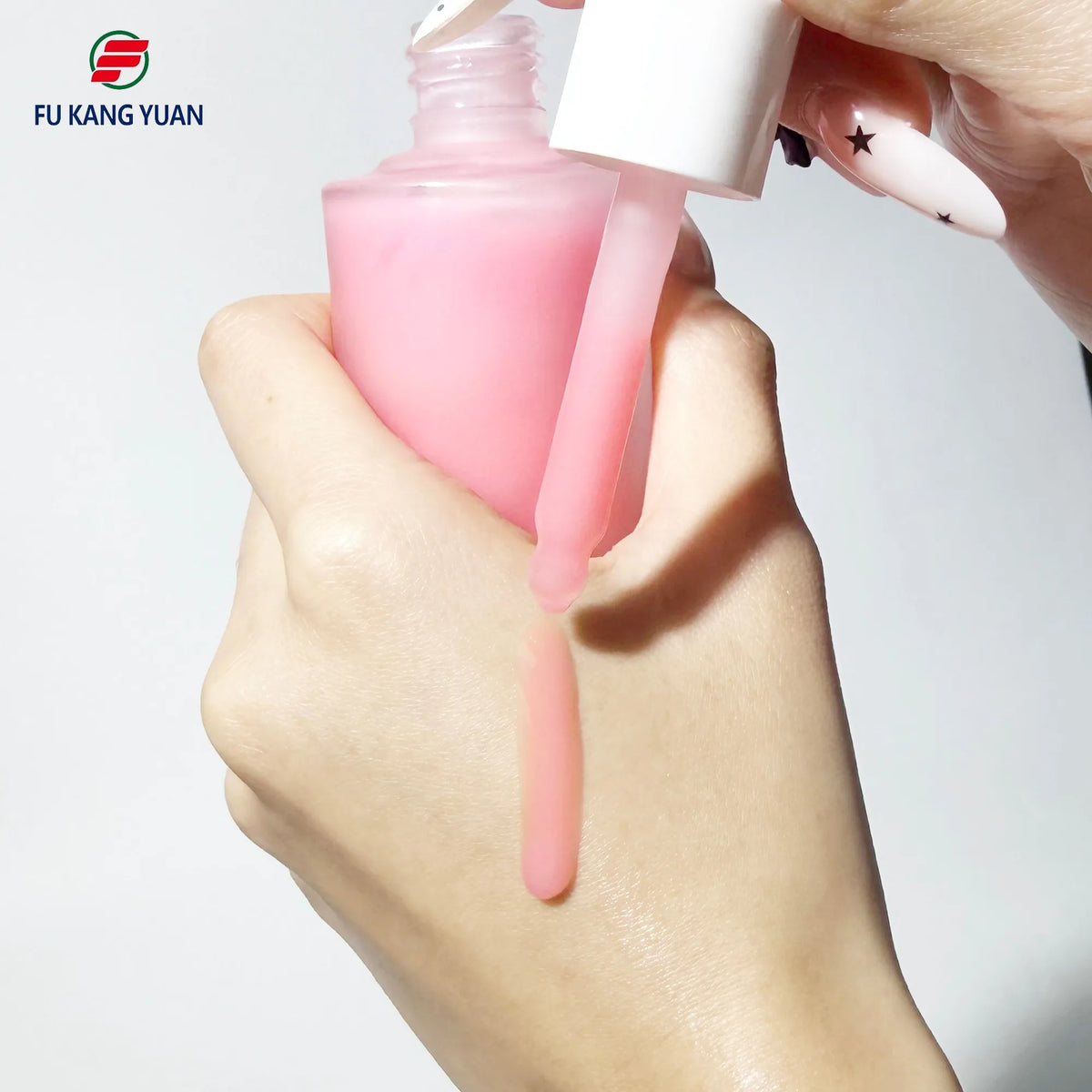 Pink FKY PDRN peptide serum dropper held over hand